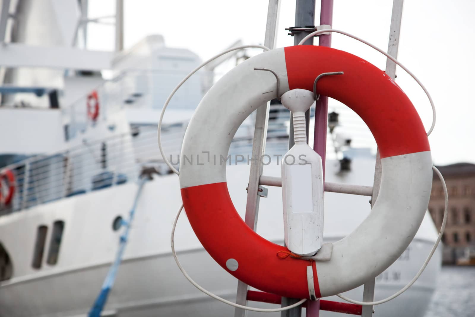 Life belt and a tourist, passenger ship in the background