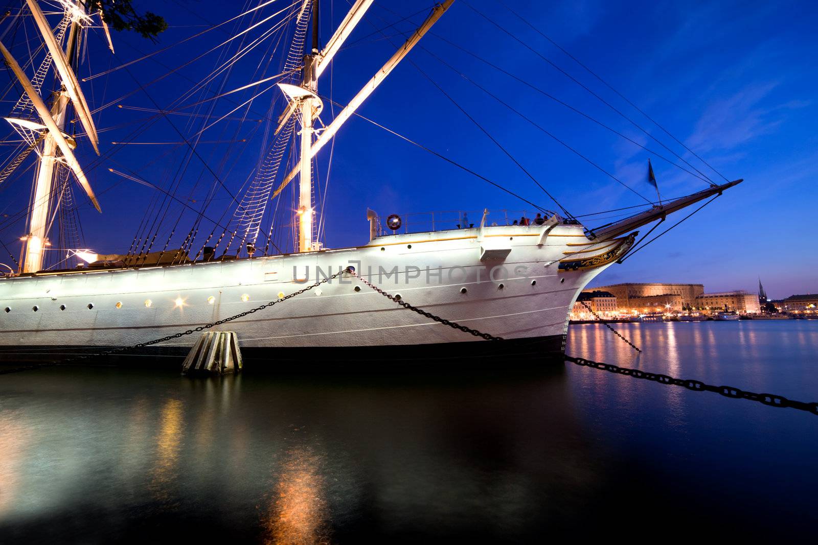 Ship at night in Stockholm, Sweden. City reflections in water