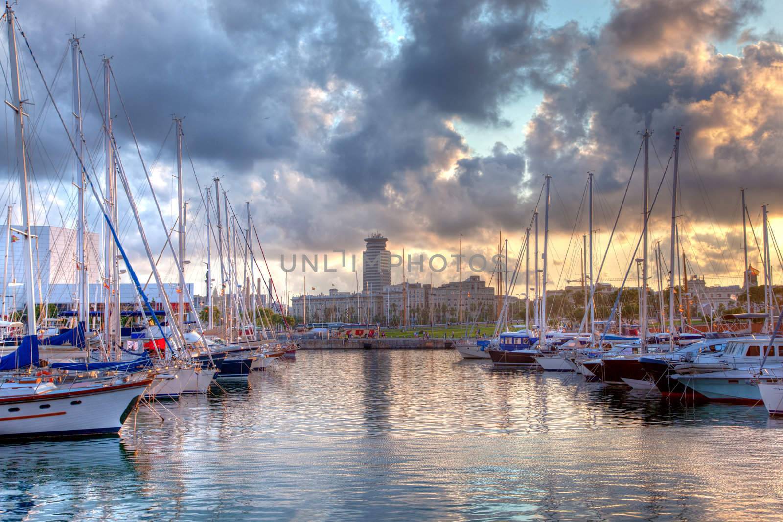 Boats in the harbor of Barcelona, Spain at sunset
