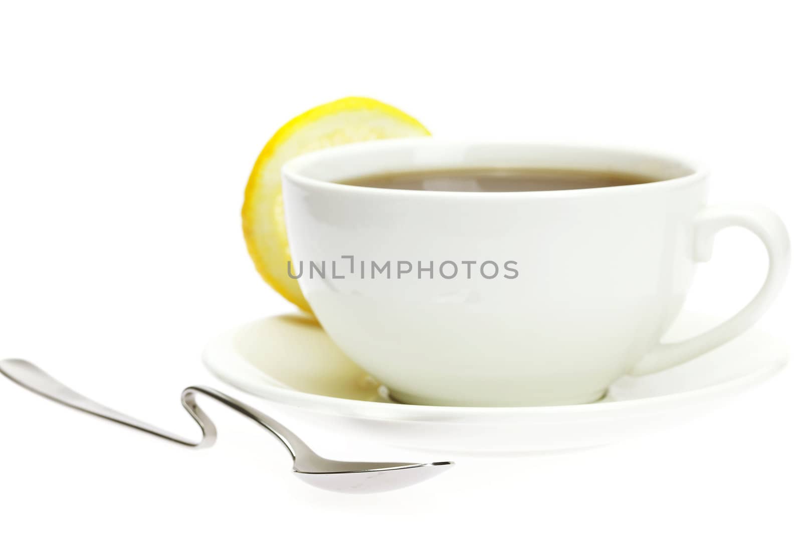 white cup, a spoon and a lemon  isolated on white by jannyjus