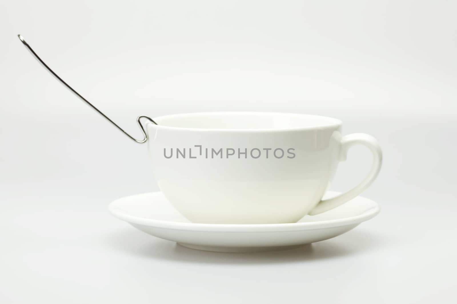 white cup and spoon isolated on white