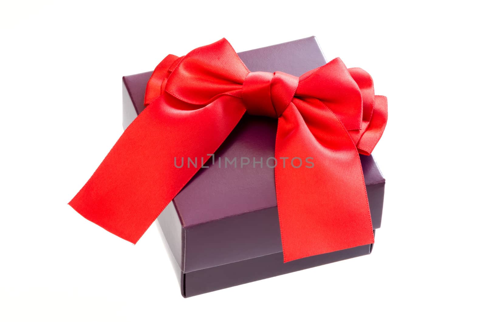 Gift box with a red ribbon bow isolated on white background.