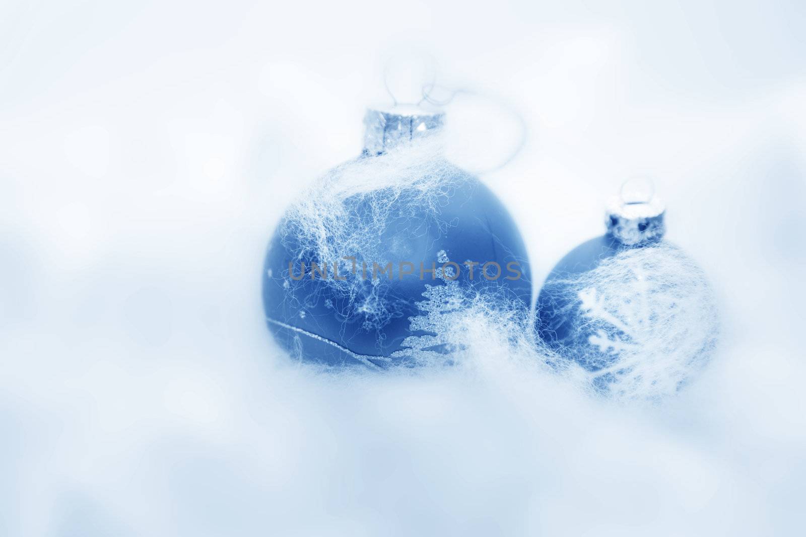 Christmas balls frozen in soft cotton wool resembling snow