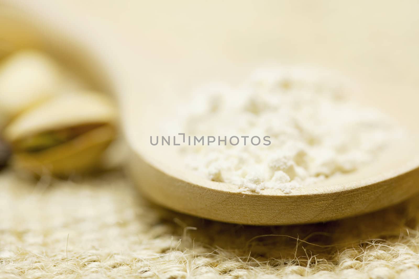 flour in a spoon  on a wicker mat by jannyjus
