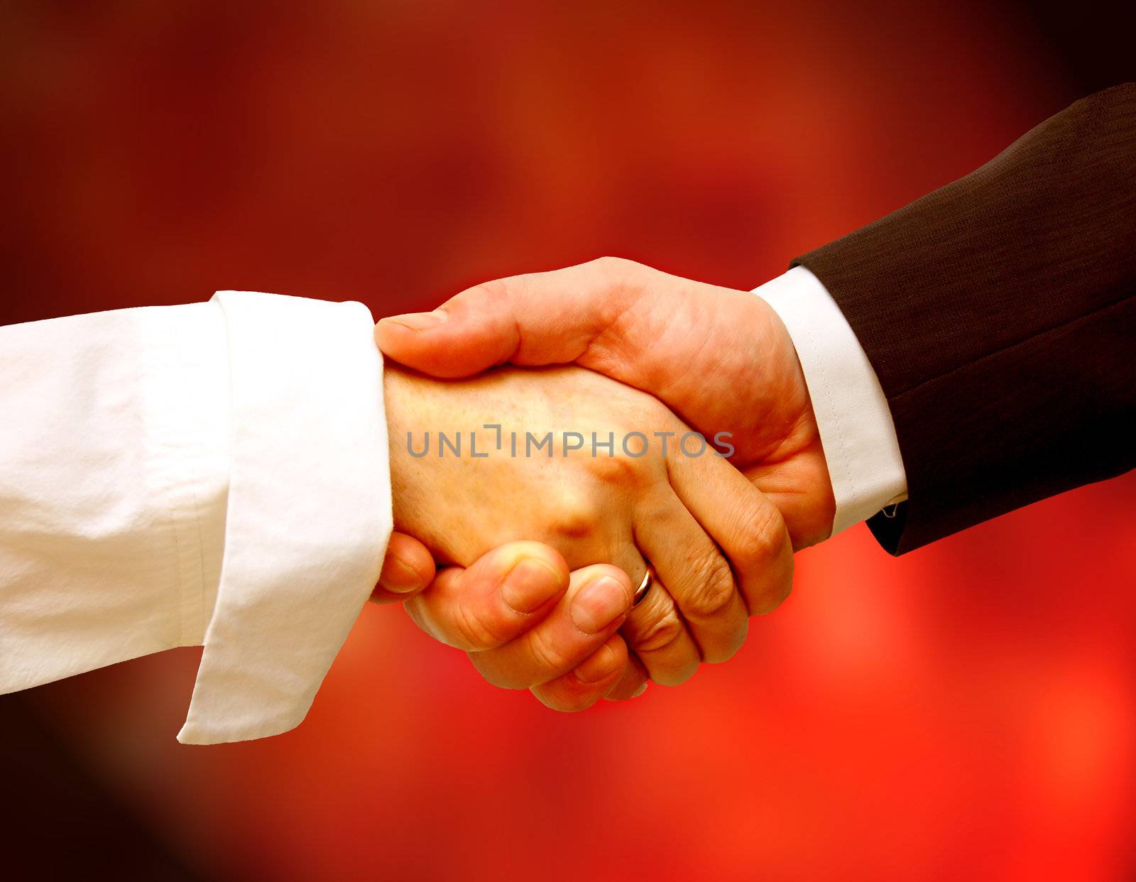 Business handshake against red background