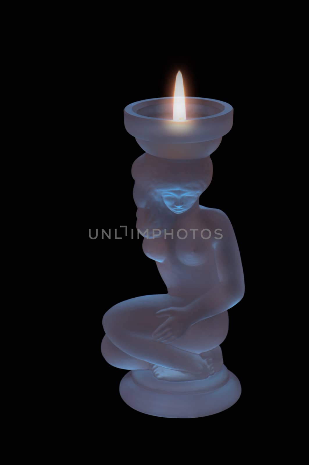 decorated crystal candle on a black background with a burning flame of a candle