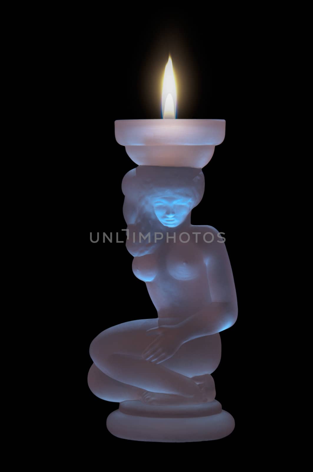 decorated crystal candle on a black background with a burning flame of a candle