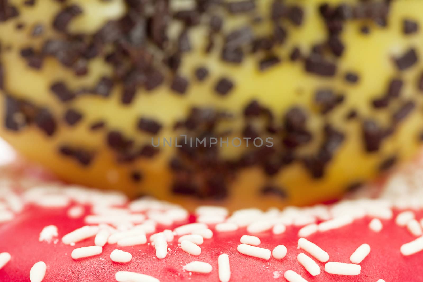 Donut with chocolate and colorful sprinkles, isolated on white by jannyjus