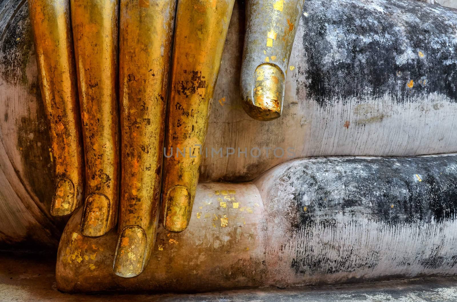 Beautiful golden hand of sitting Buddha in Wat Si Chum temple in Sukhothai, Thailand