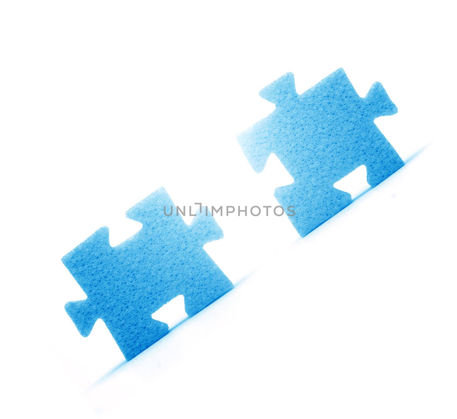 Putting two pieces of puzzles together. Conceptual image