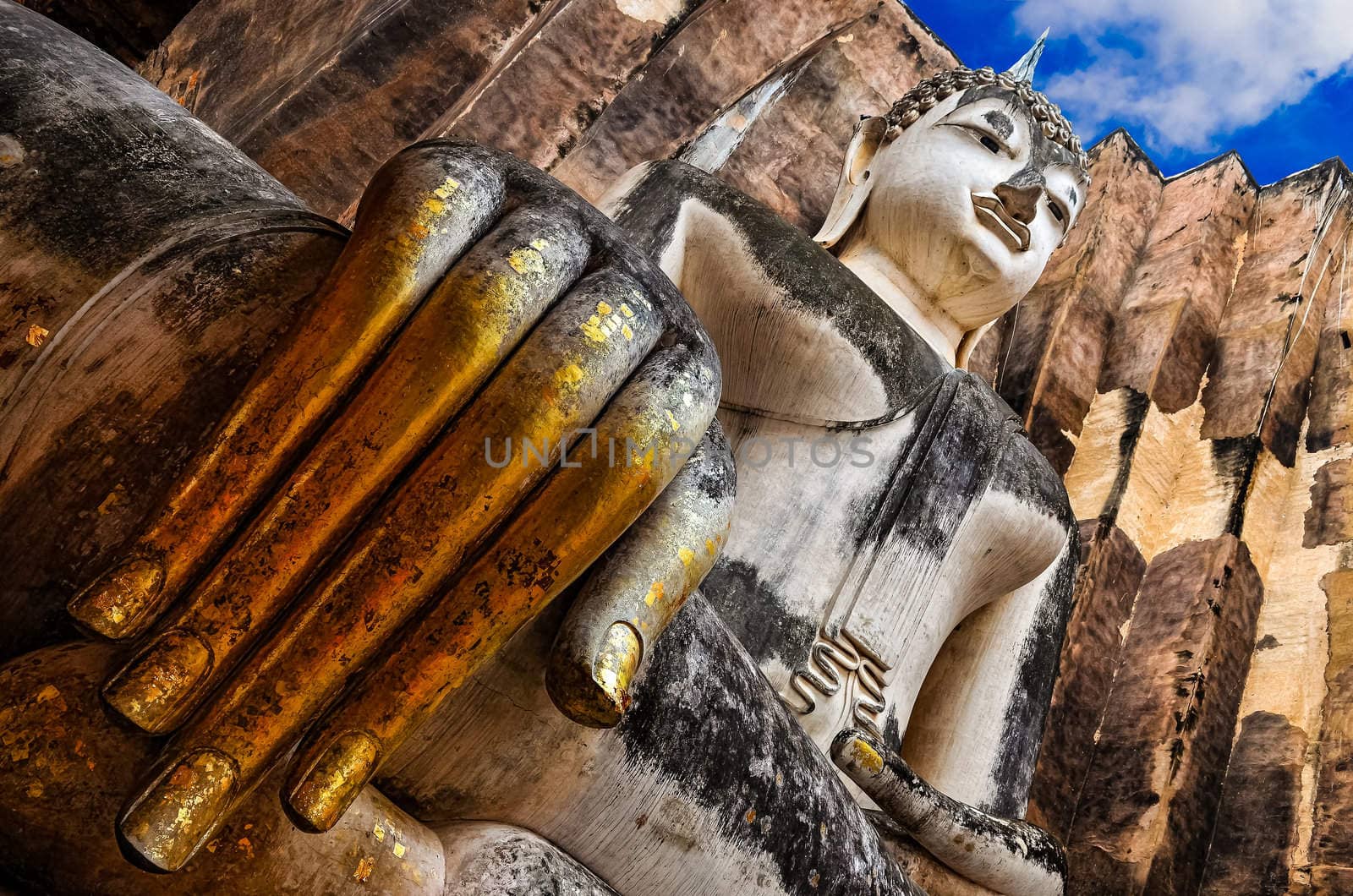Sitting Buddha with golden hand in Wat Si Chum temple, Sukhothai, Thailand