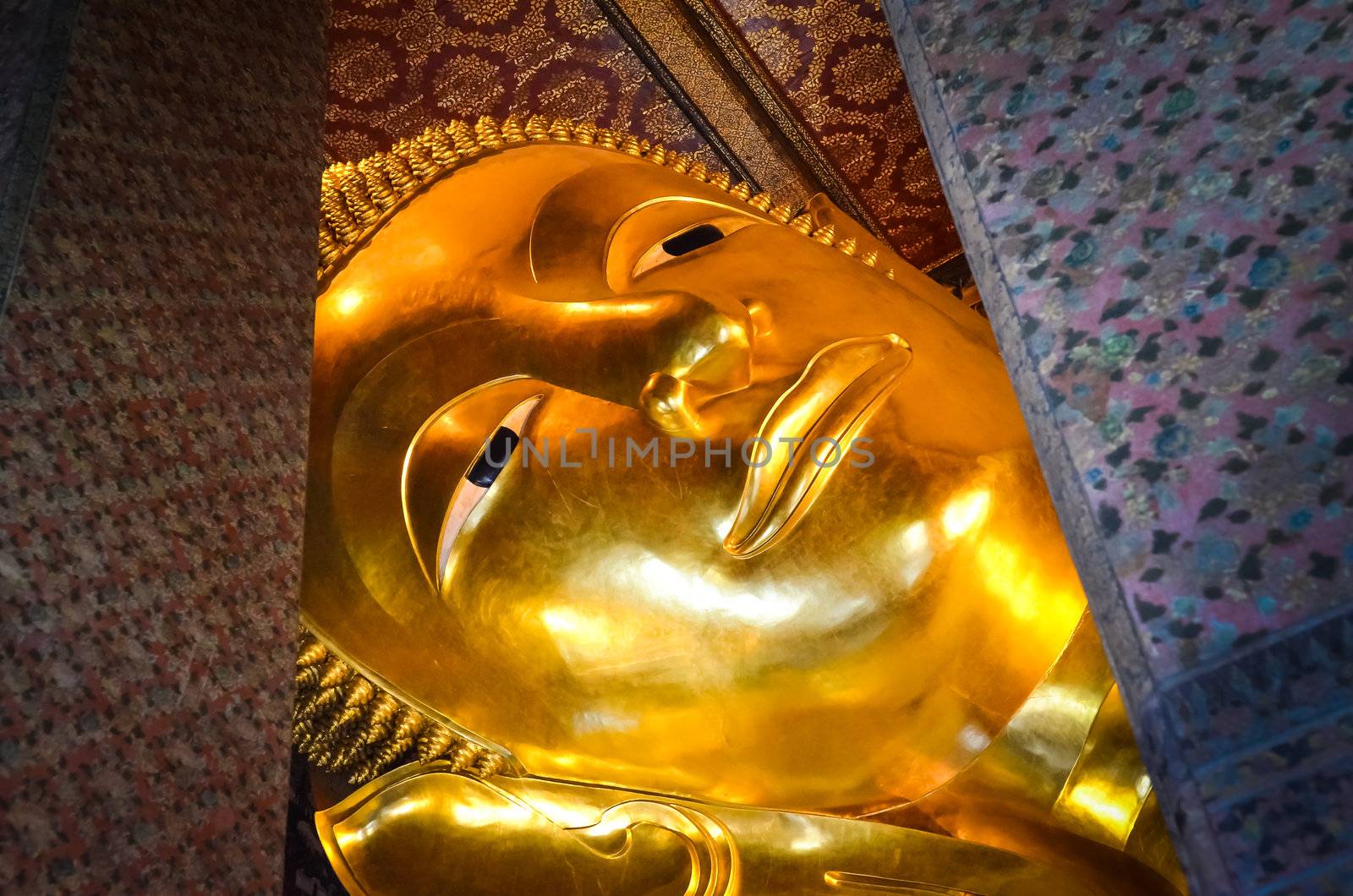 Reclining Buddha gold statue face in Wat Pho, Bangkok by martinm303