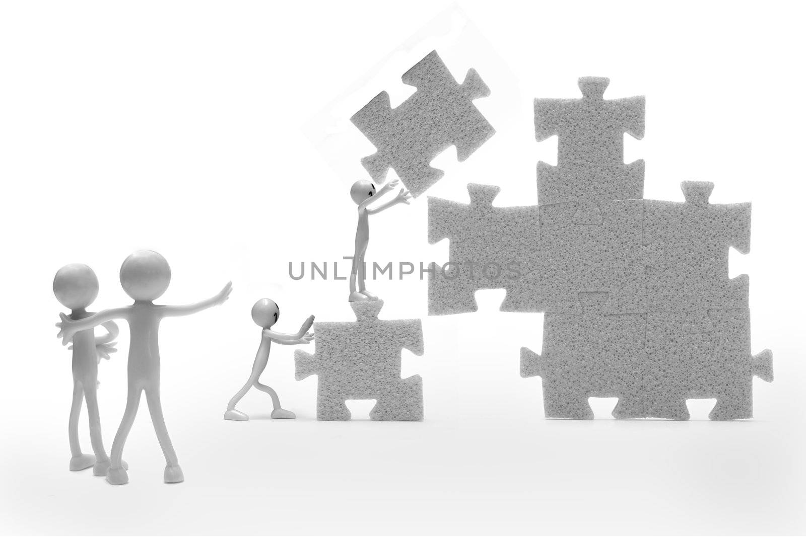 Business teamwork concept. A group building a puzzle construction