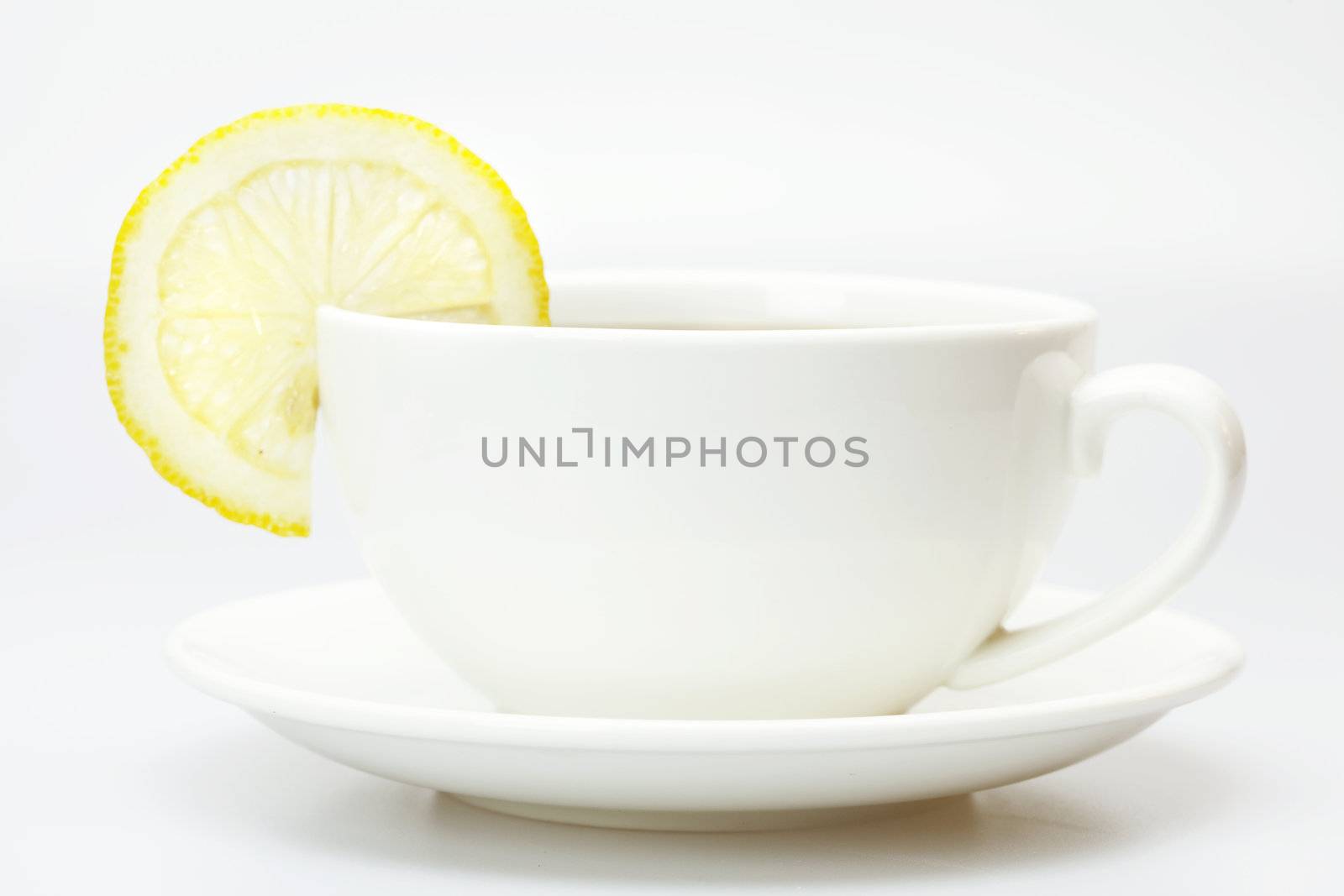 white cup and lemon isolated on white by jannyjus