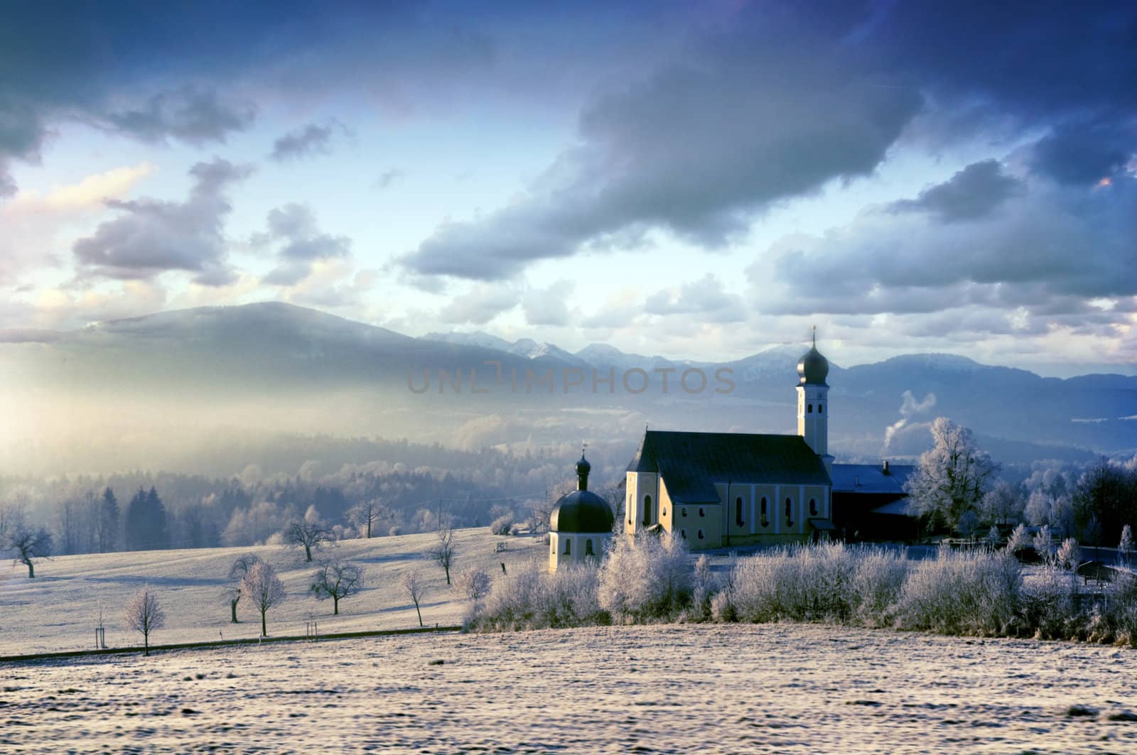 Beautiful frosty morning in the alpine scenery with pictursque church