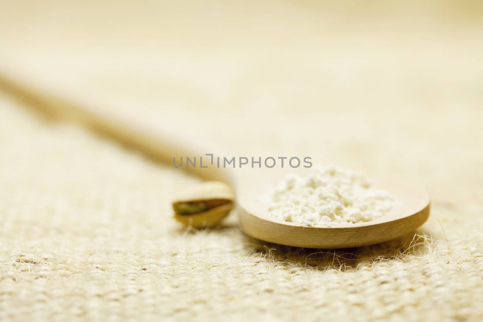 flour in a spoon on a wicker mat