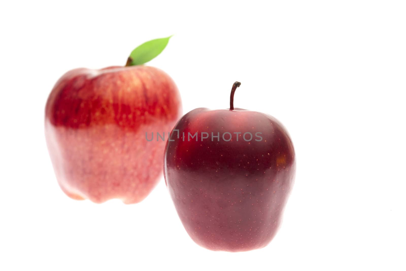 red apples with leaves isolated on white
