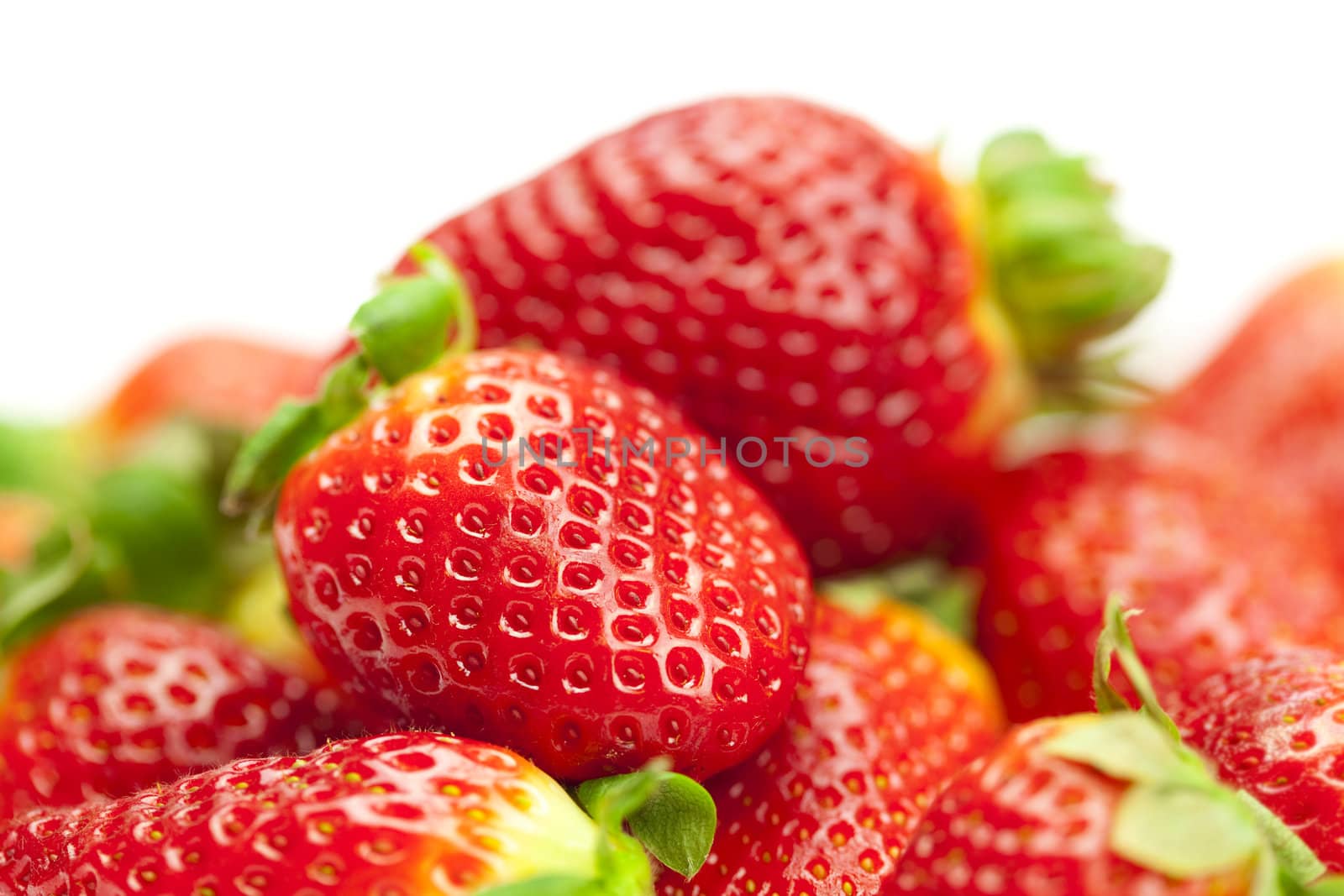 juicy strawberries isolated on white by jannyjus