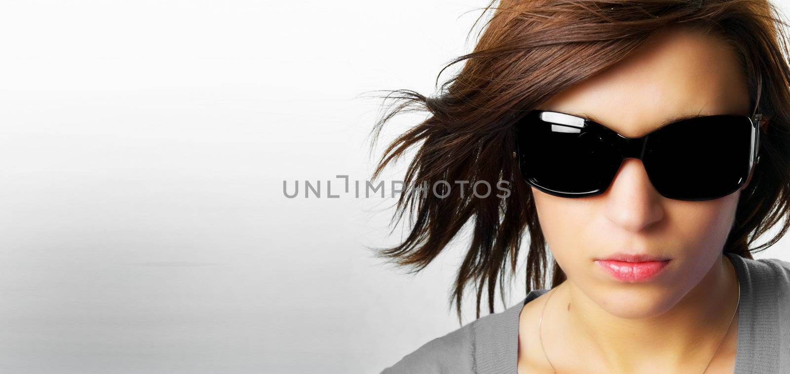 Modern, stylish portrait of a beautiful young woman with a lot of copyspace