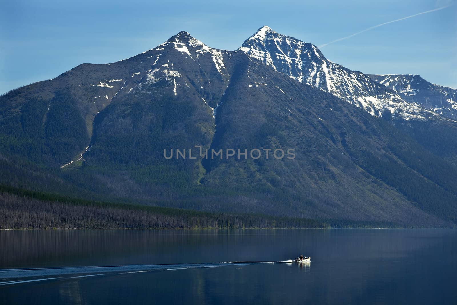 Lake McDonald Going Fishing Outboard in front of Snow Mountain Glacier National Park Montana