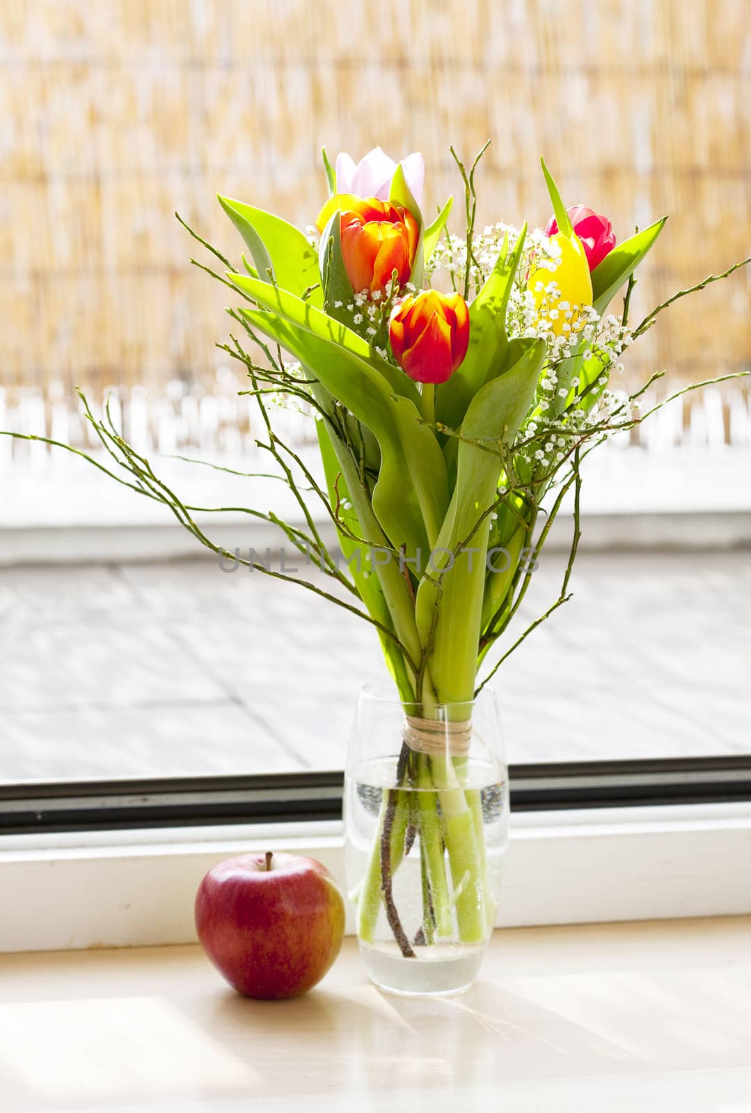 spring bouquet with tulips and an apple