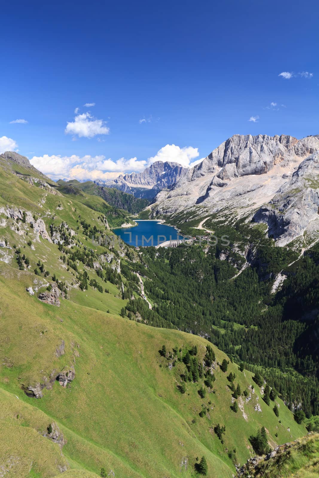 summer view of mount Marmolada and Fedaia lake, Trentino, Italy - Vertical composition