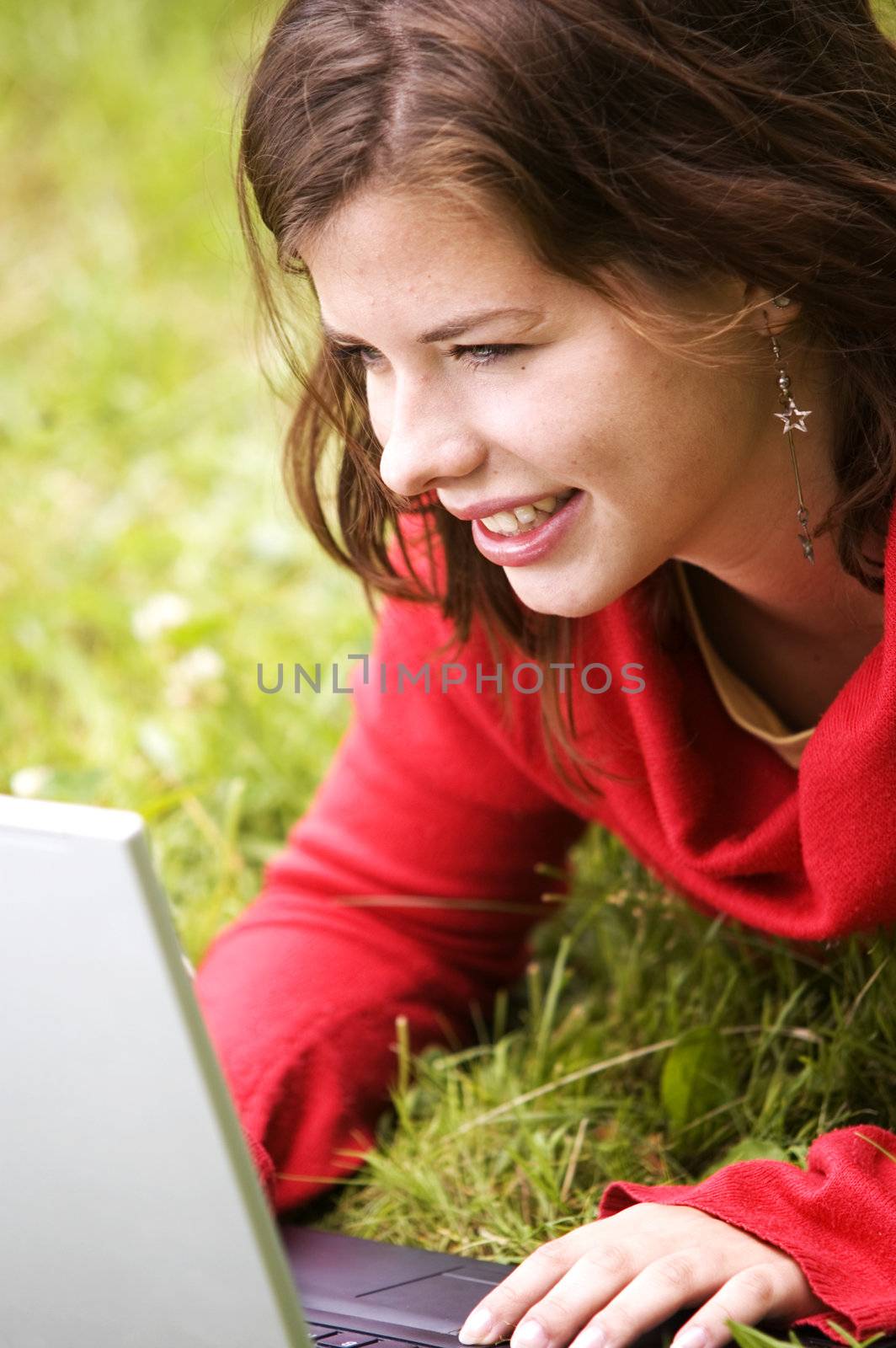 A beutiful student girl working on her laptop outdoor at sunny day