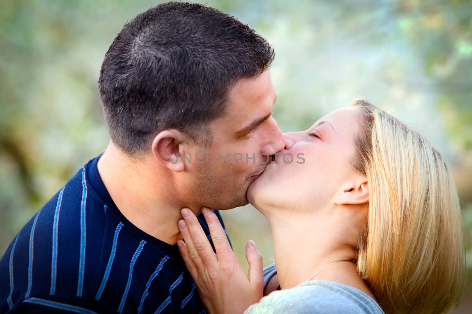 Love kissing. Happy couple kissing in romantic scenery