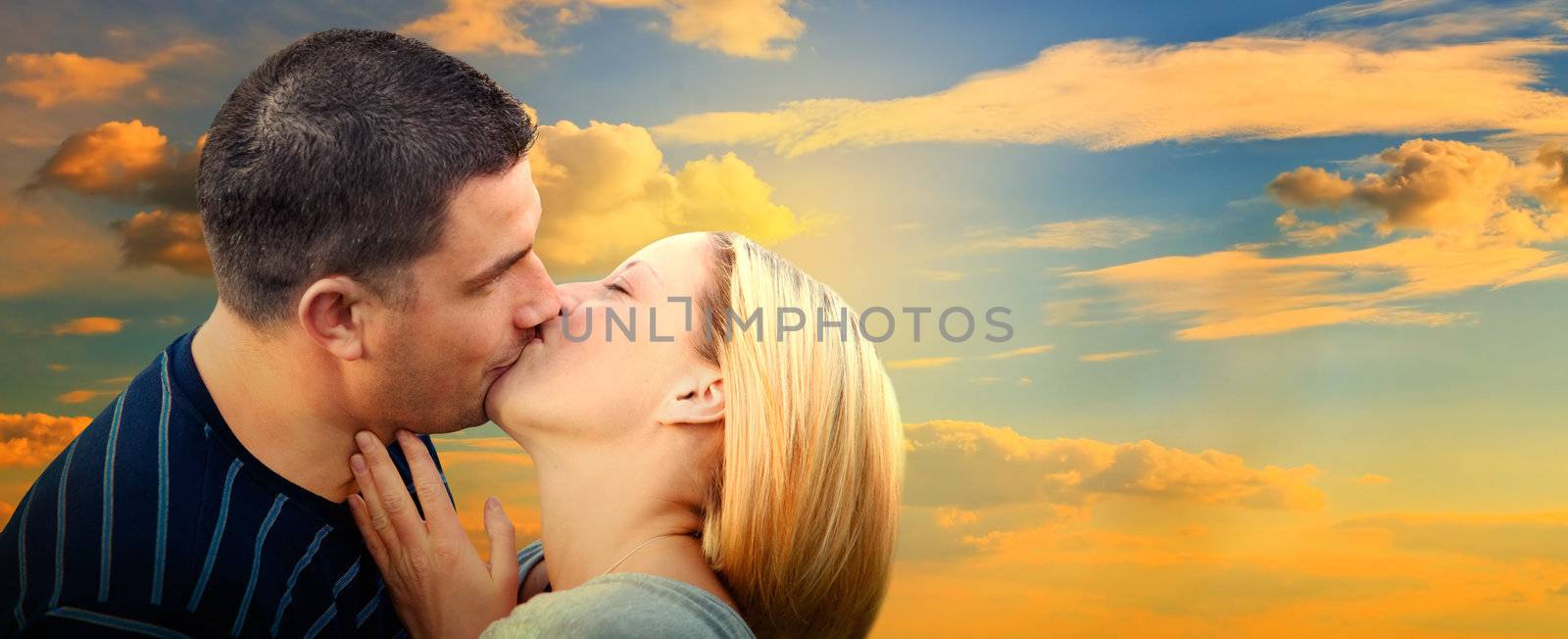 Couple kissing in romantic love scenery on sunset sky. Panorama version