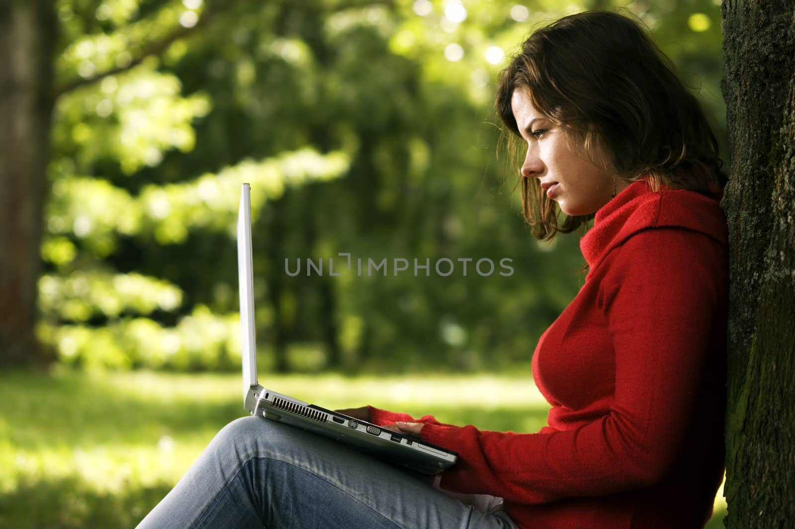 Student girl working on her laptop by photocreo