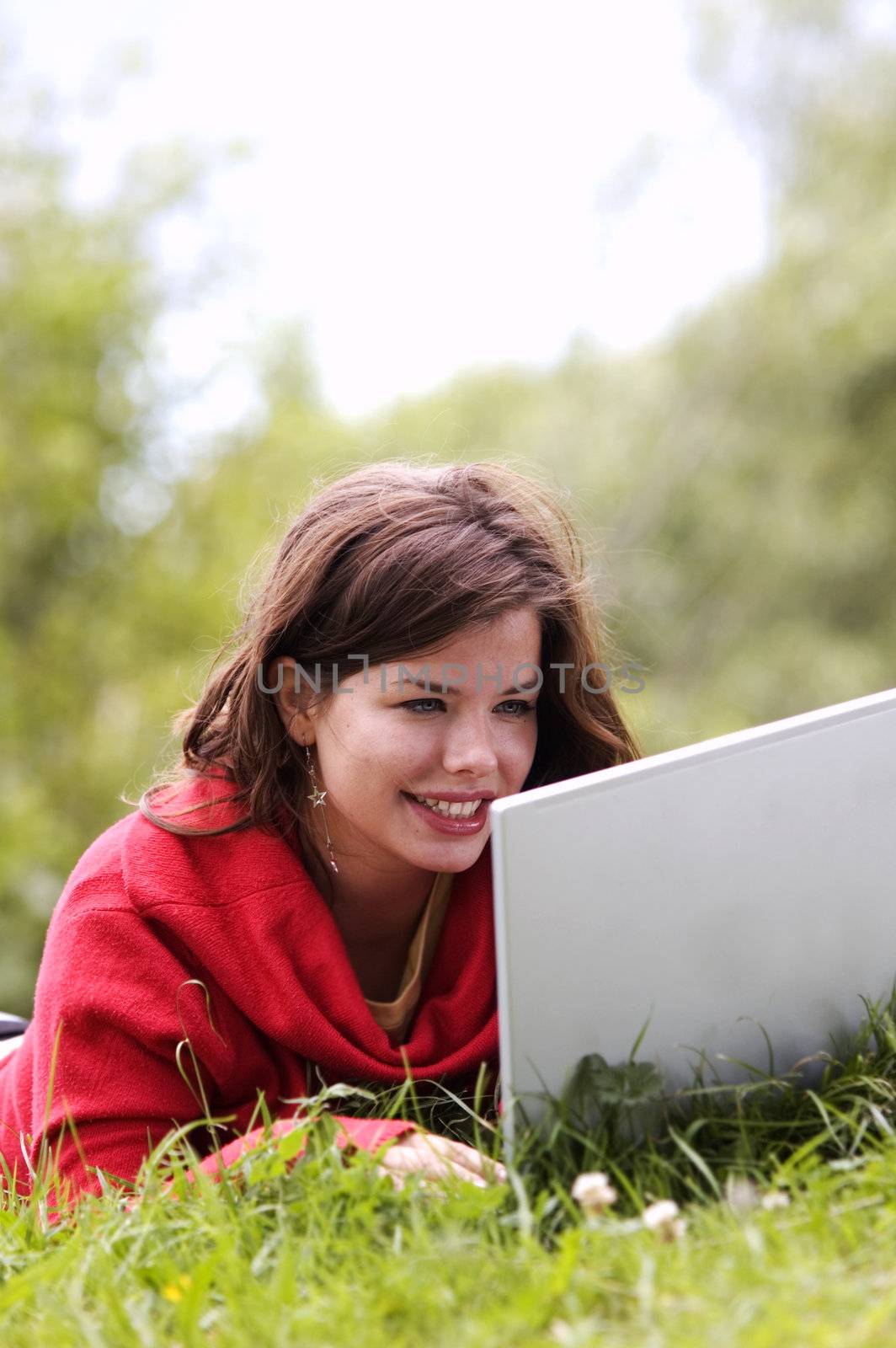 A beutiful student girl working on her laptop outdoor at sunny day