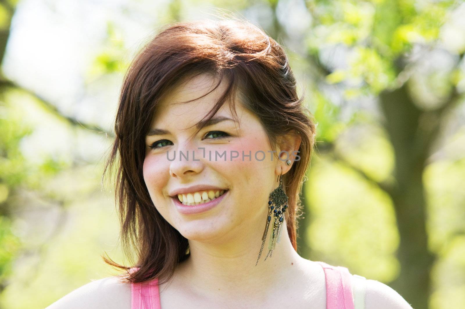 Young happy girl portrait on nature background