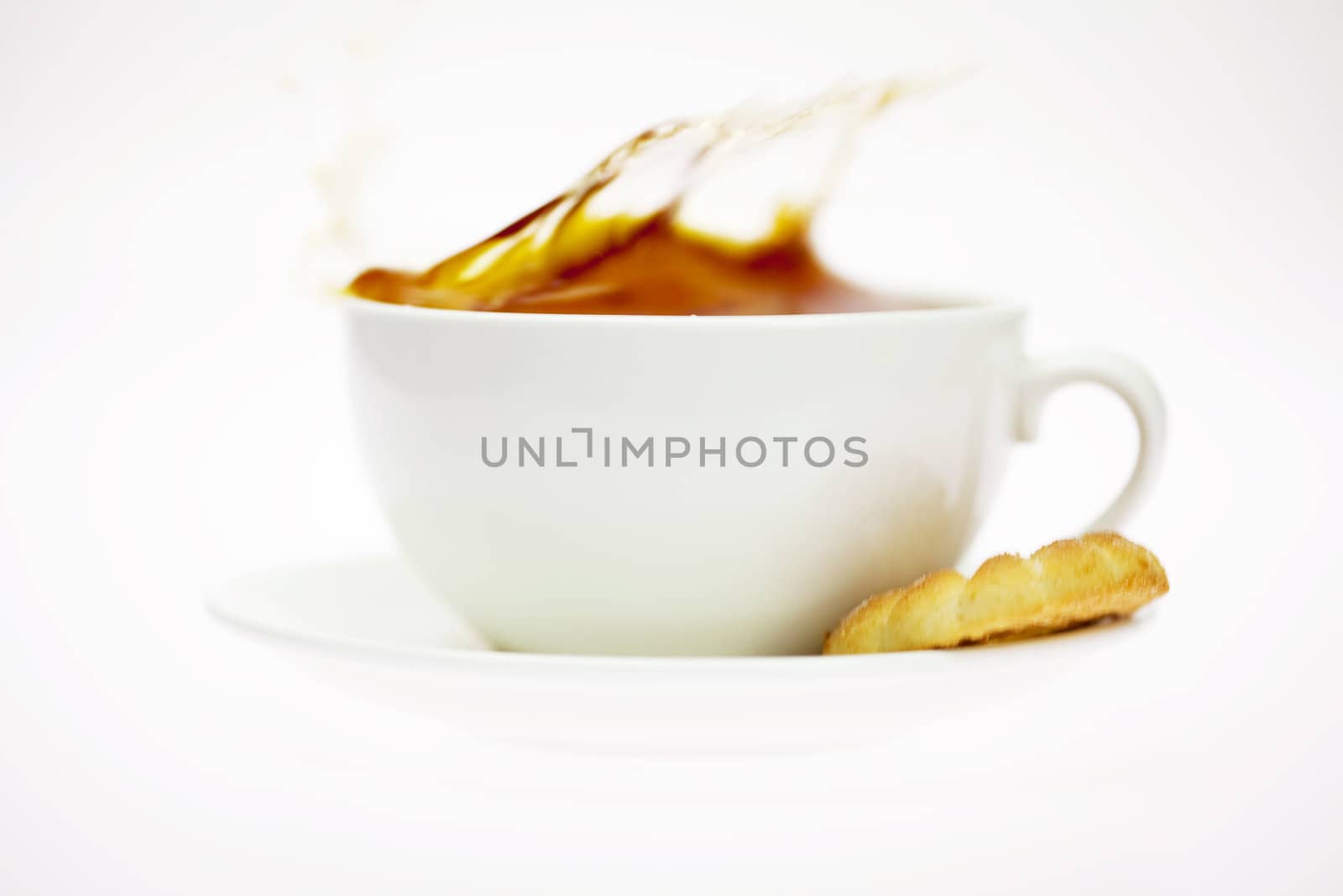 white cup with a pastry isolated on white