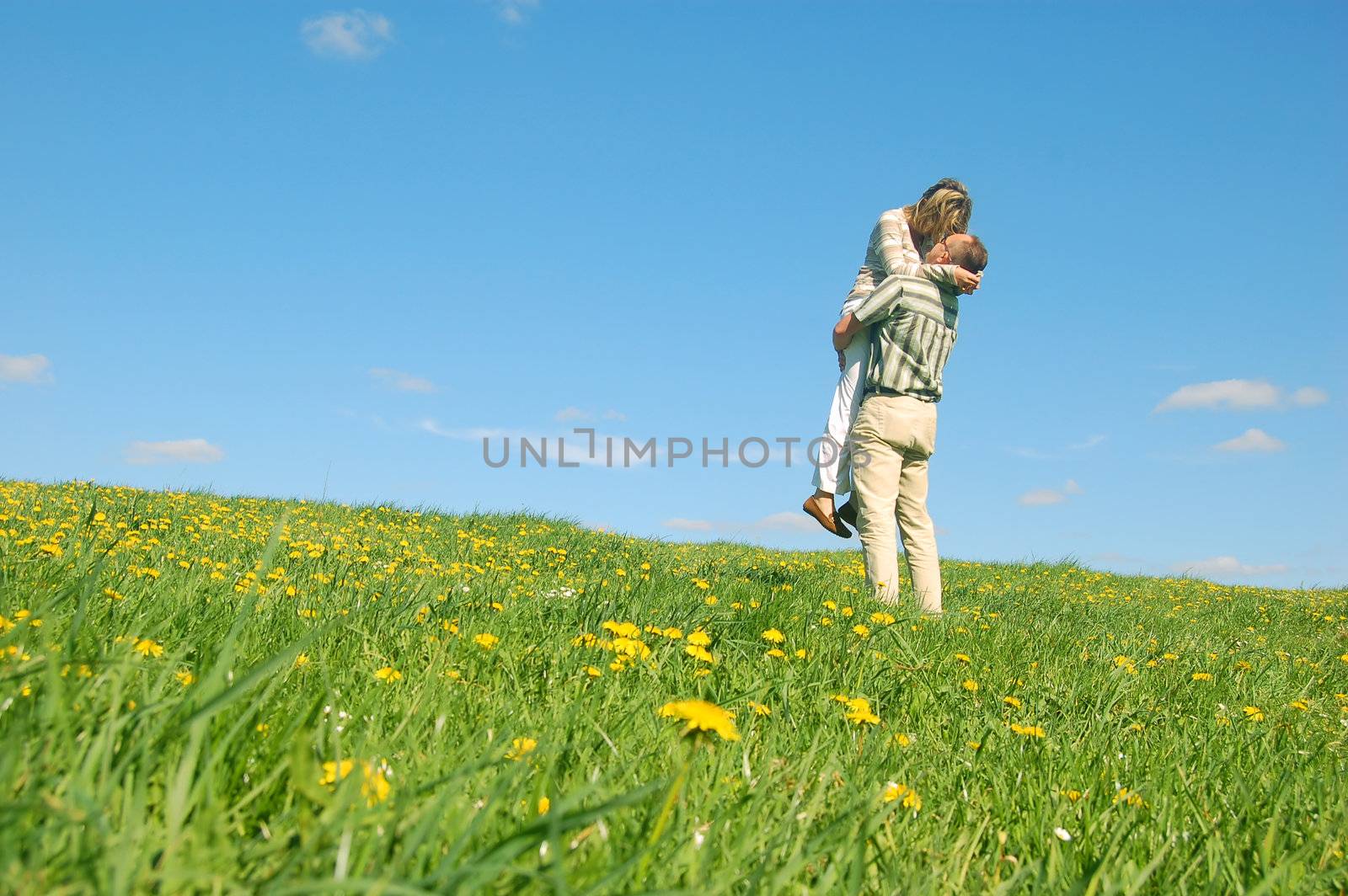 Couple in love having fun on spring meadow