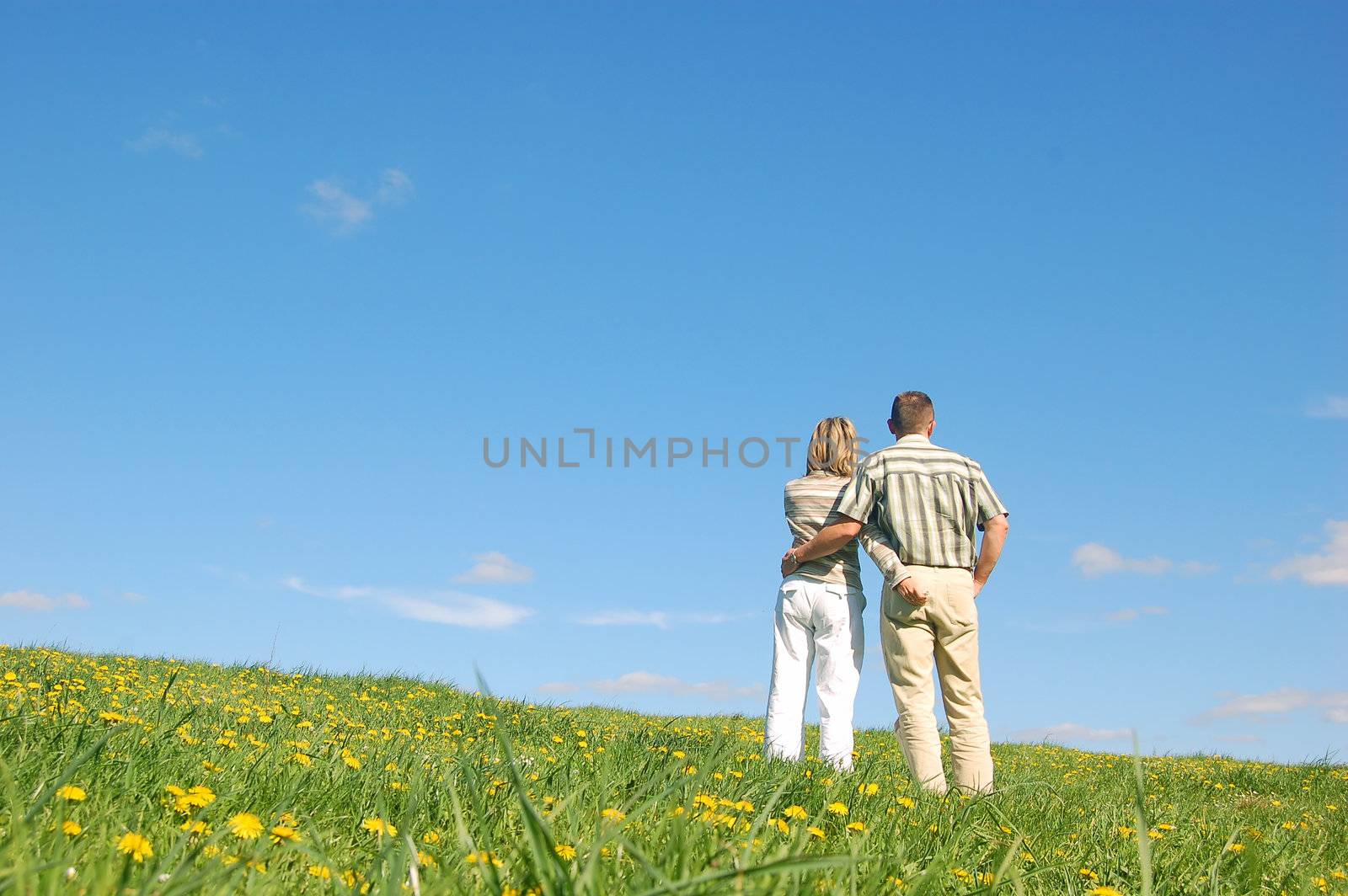 Couple in love on meadow by photocreo
