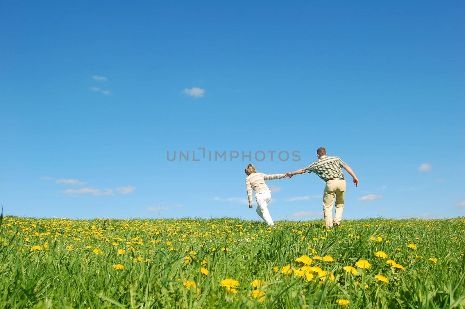 Couple in love having fun on spring meadow