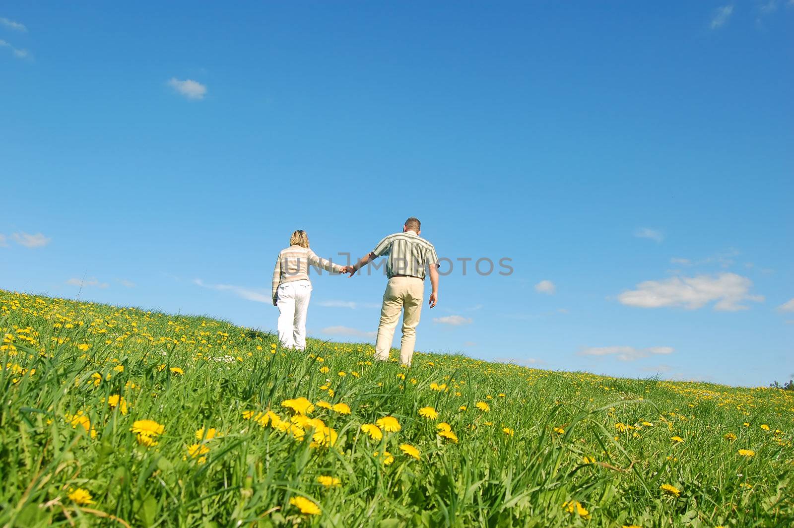 Couple in love having fun on spring meadow