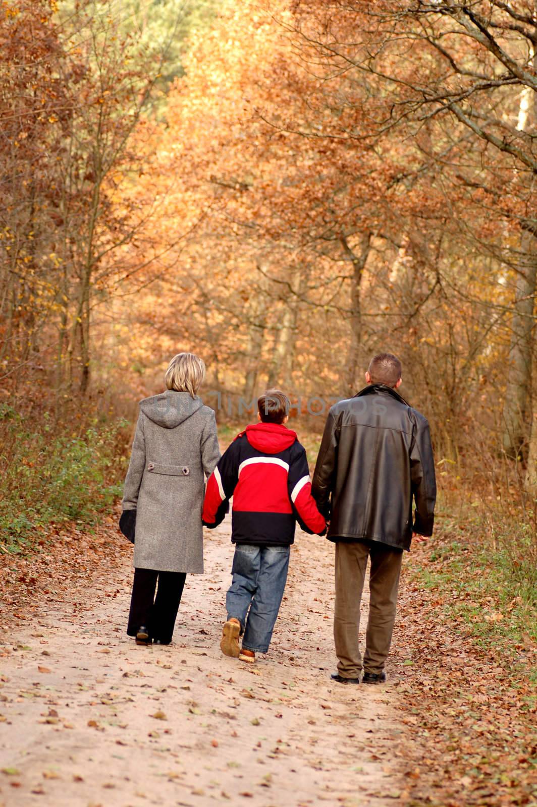 Family walk in autumn scenery