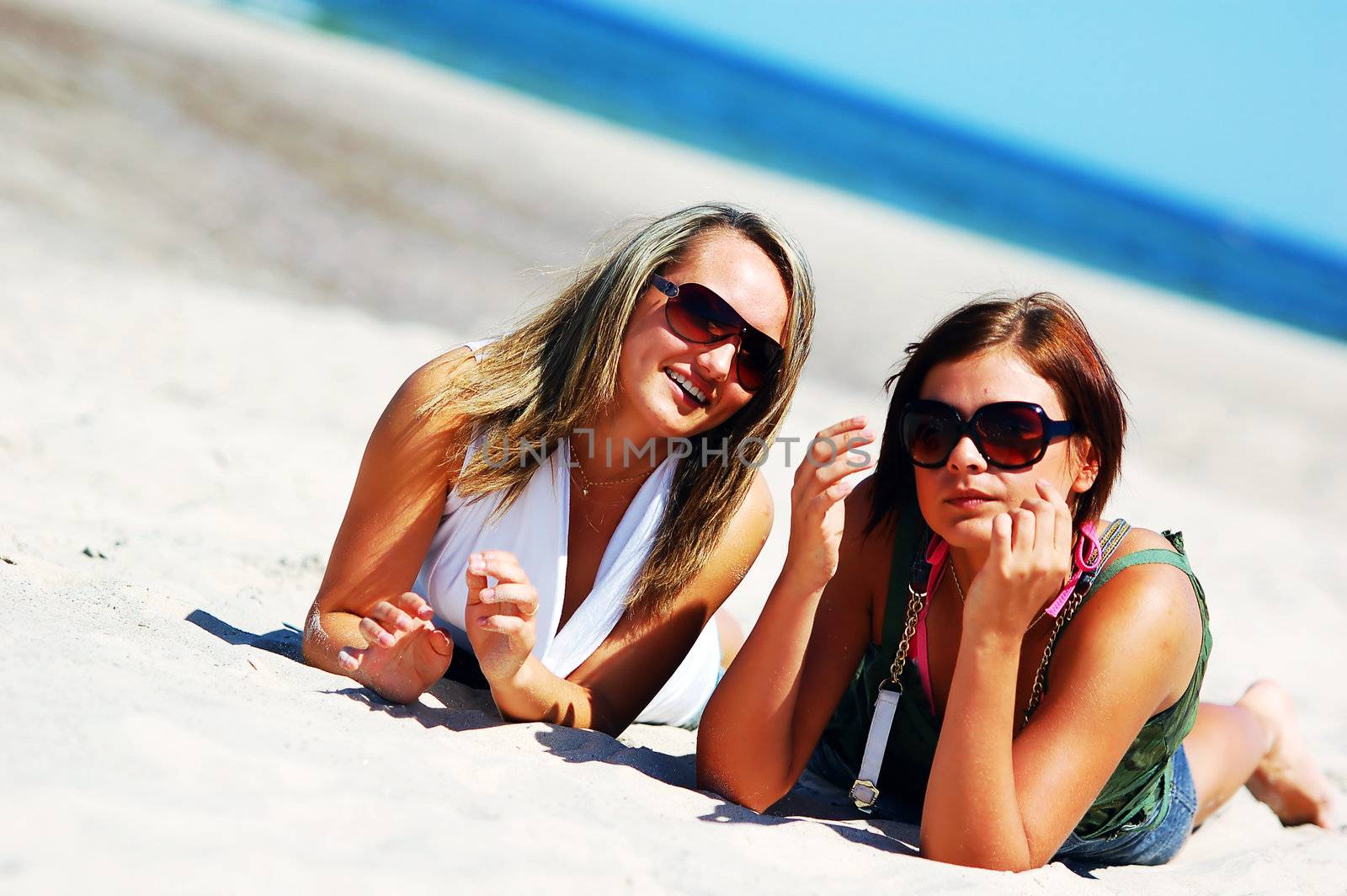 Young attractive girls enjoying together the summer beach