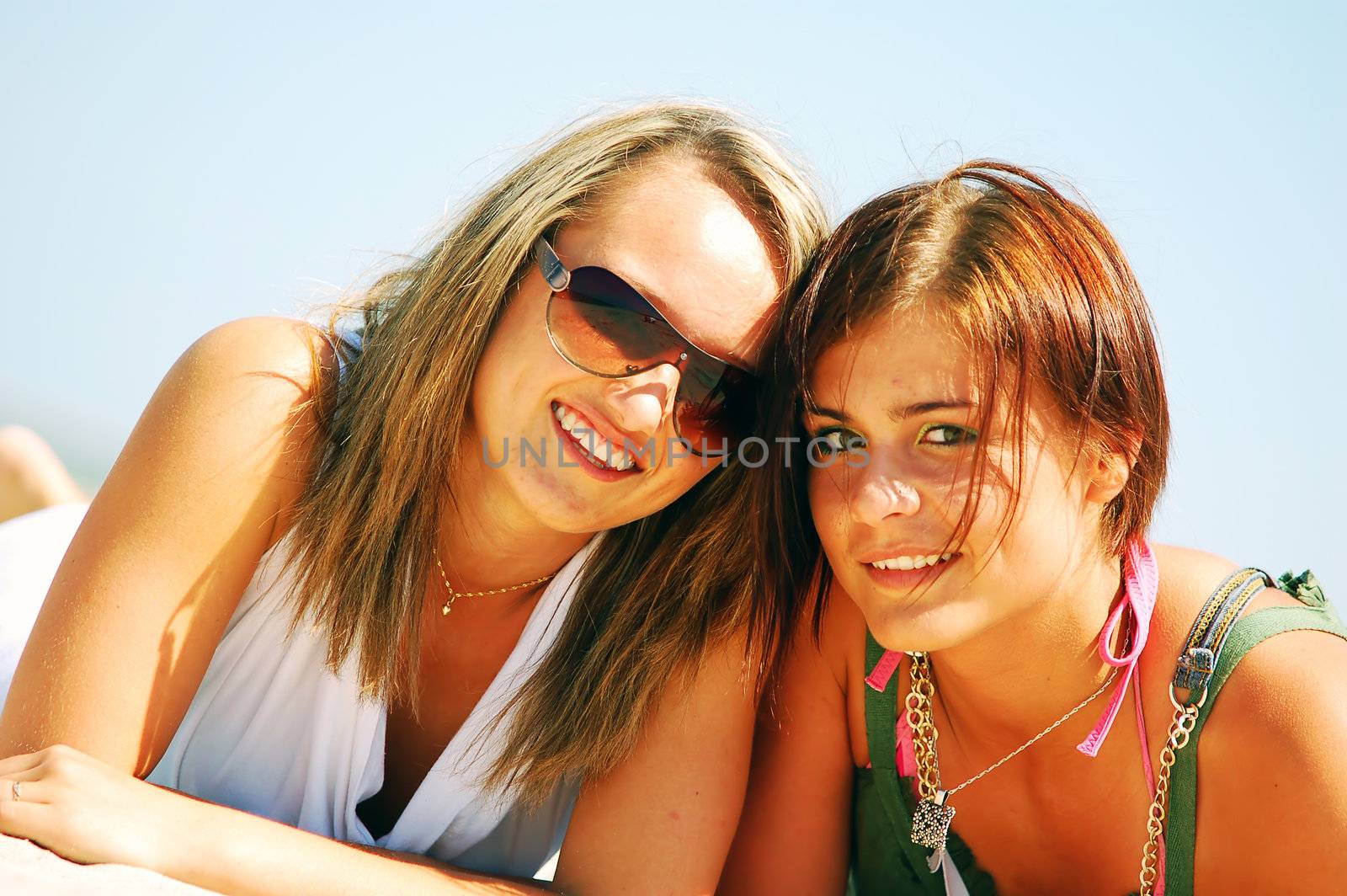 Young attractive girls enjoying together the summer beach