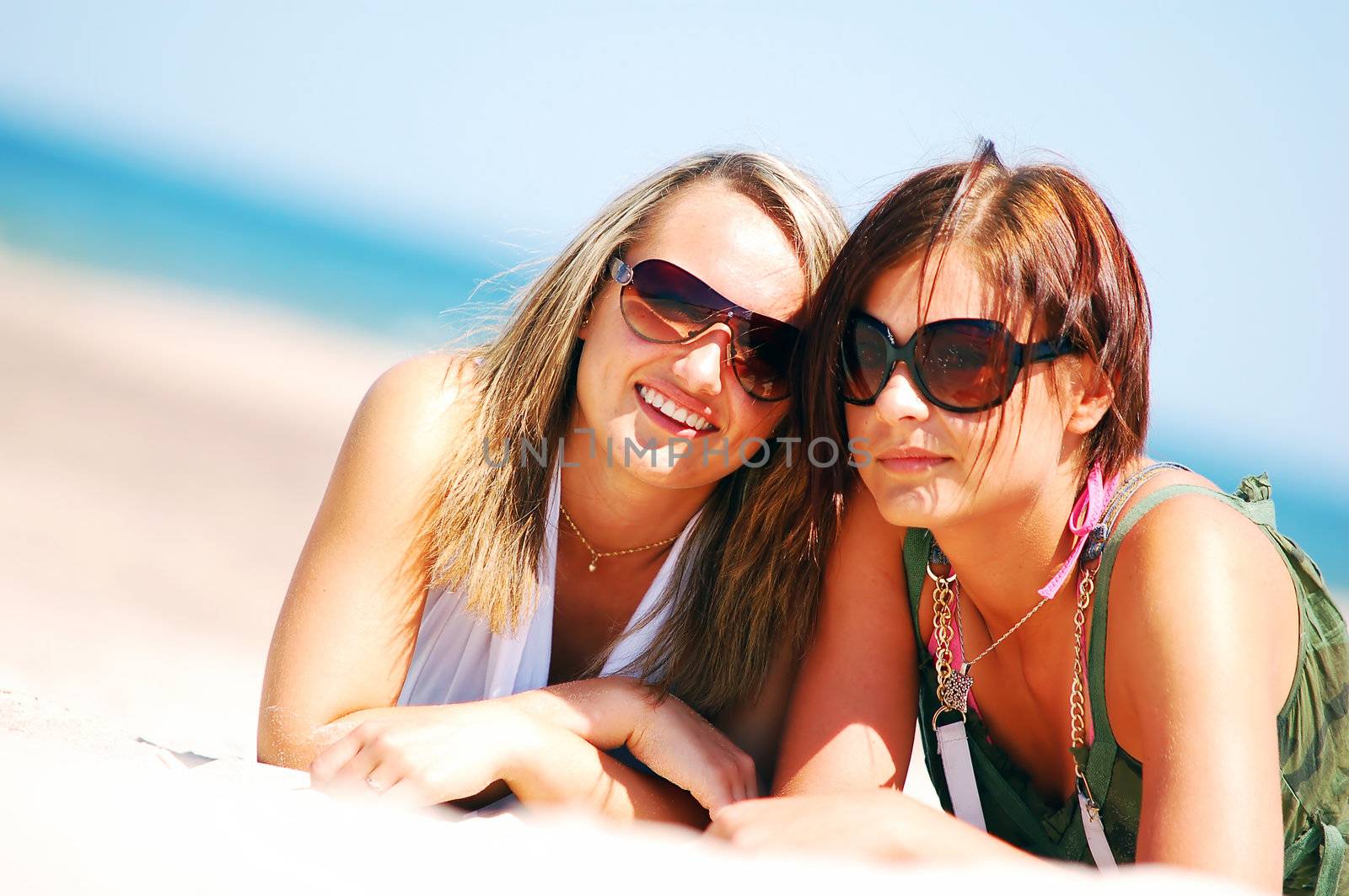 Young attractive girls enjoying together the summer beach