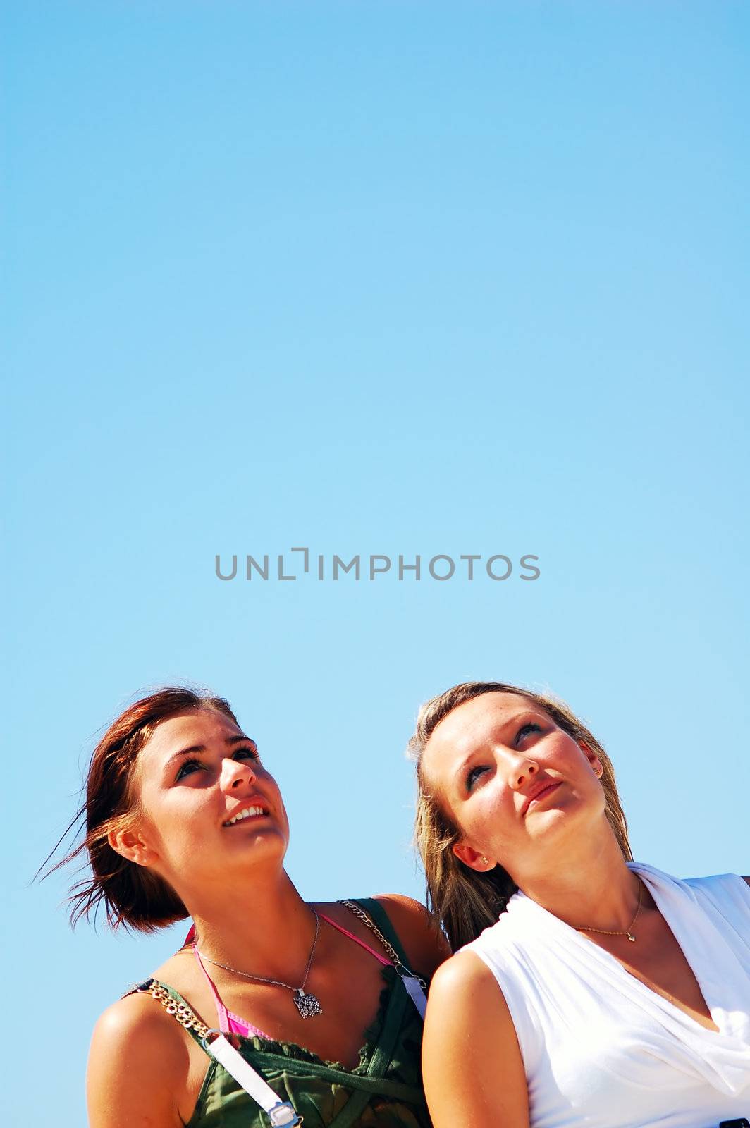 Young attractive girls looking up to the sky