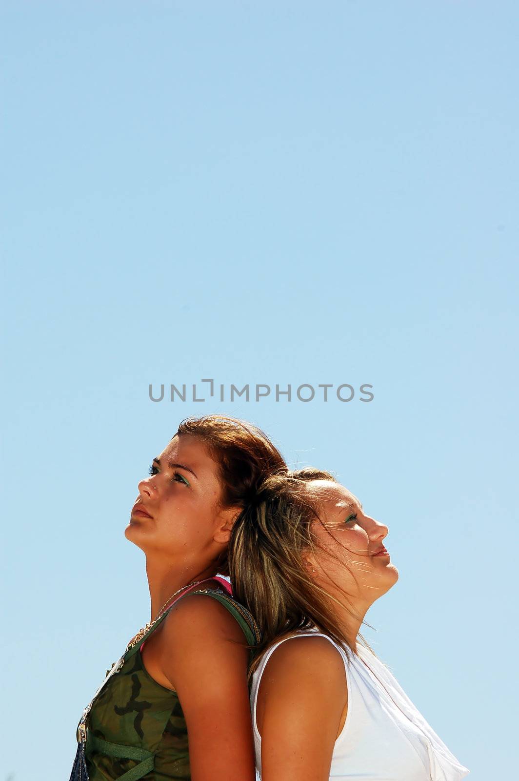 Young attractive girls looking up to the sky