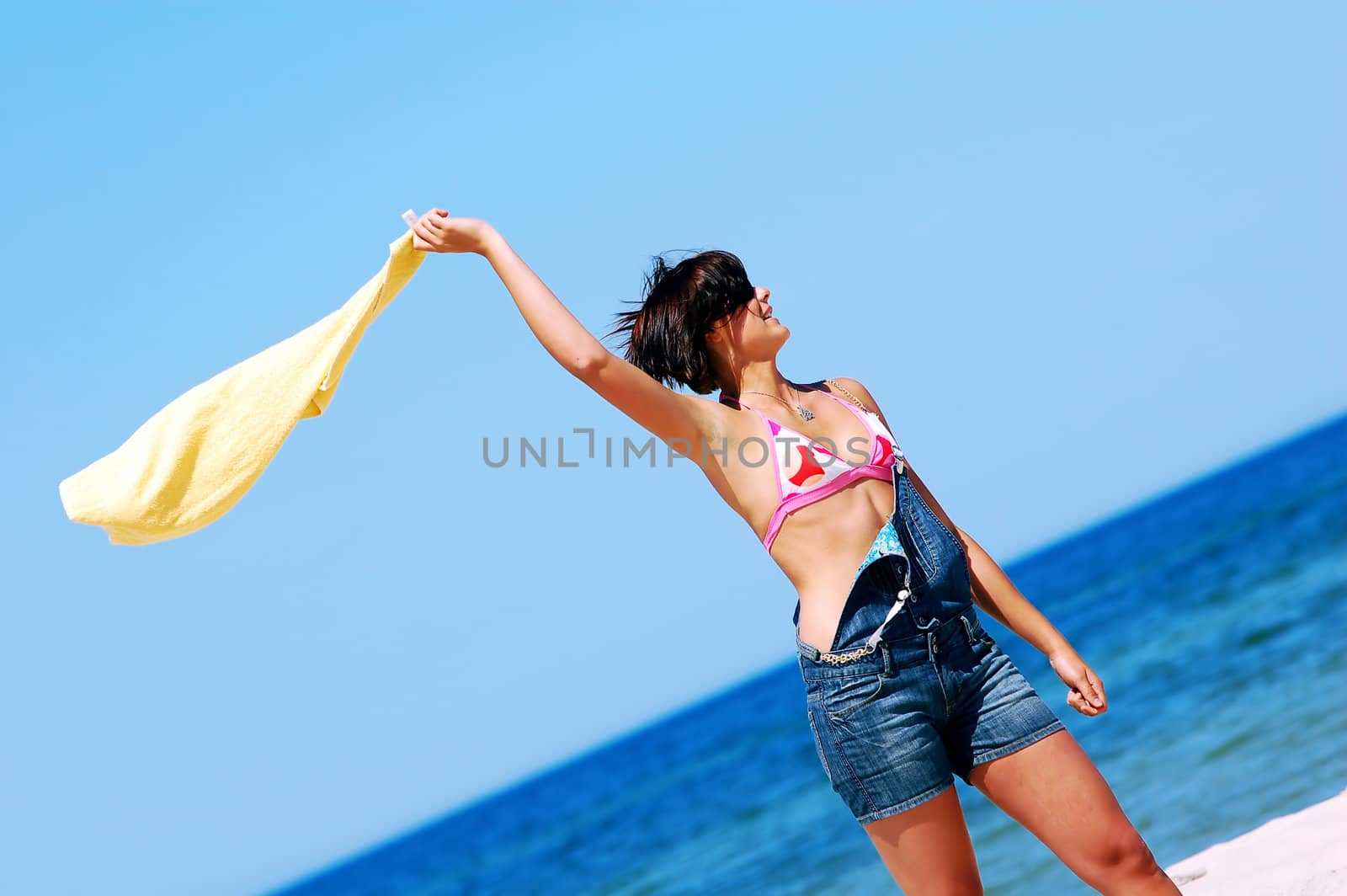 Young attractive woman enjoying summertime on the beach