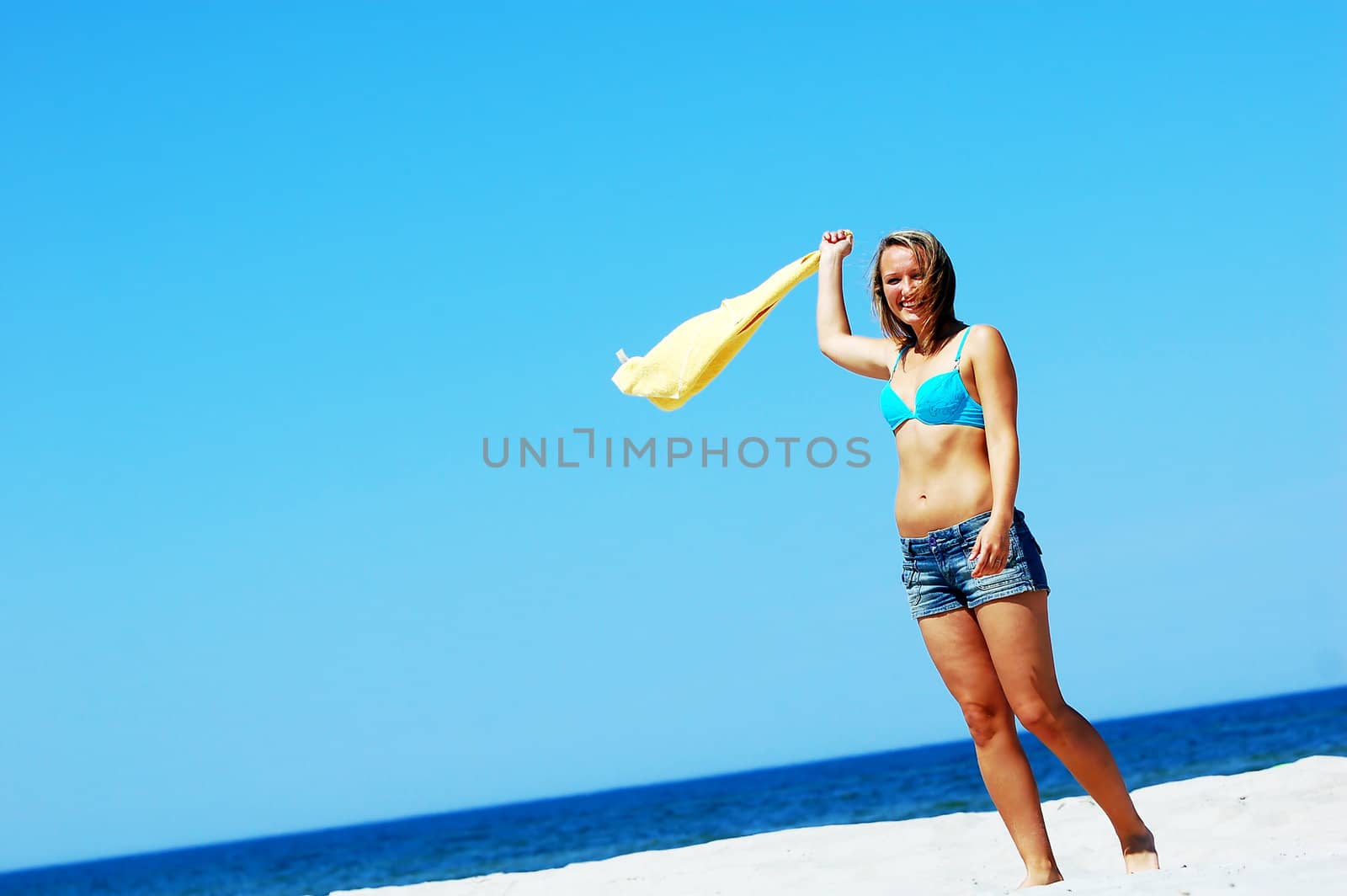 Young attractive woman enjoying summertime on the beach