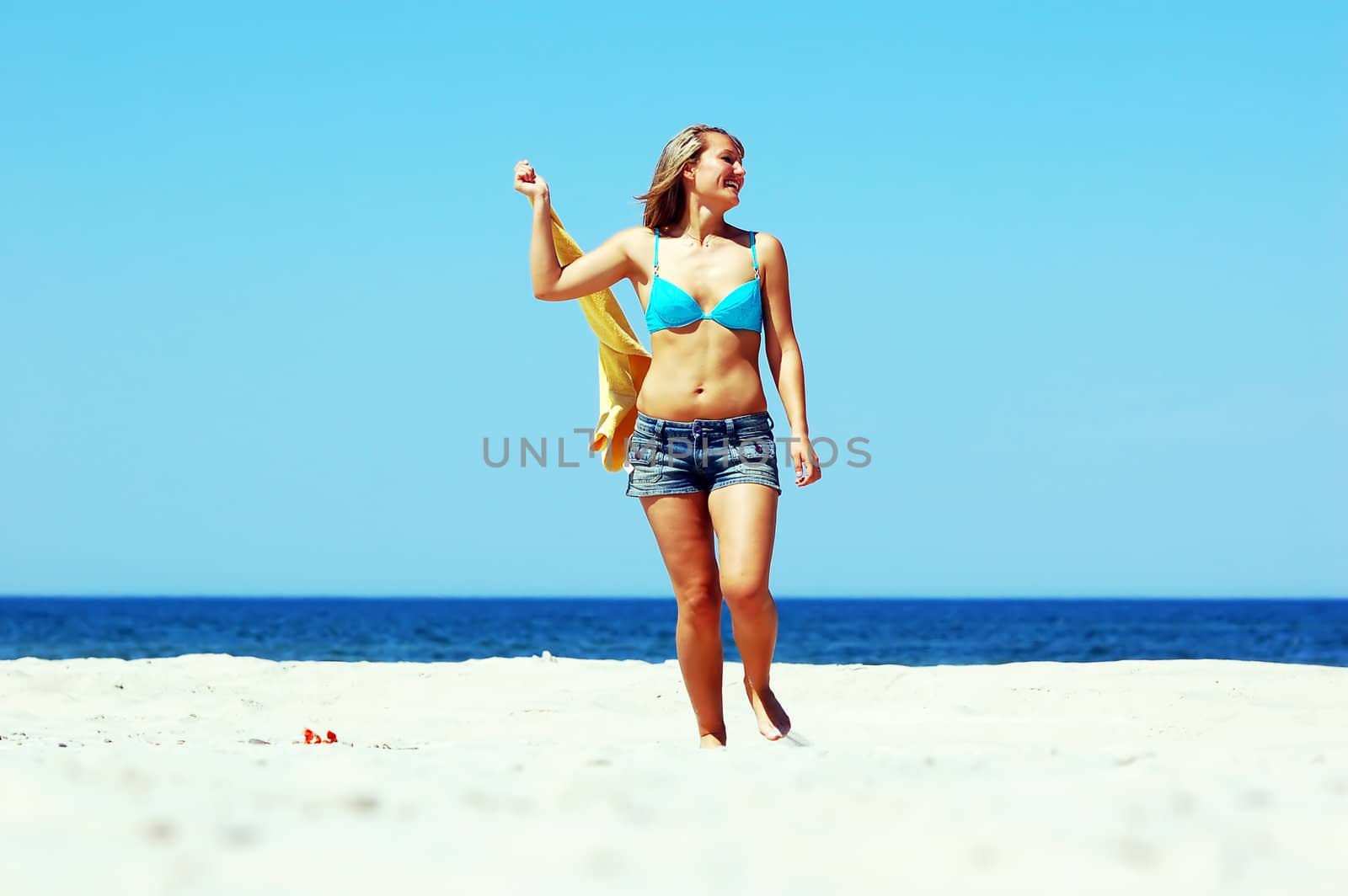 Young attractive woman enjoying summertime on the beach