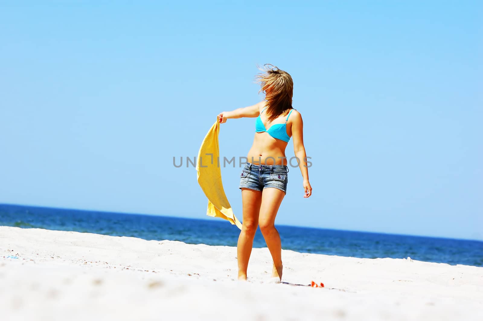 Young attractive woman enjoying summertime on the beach