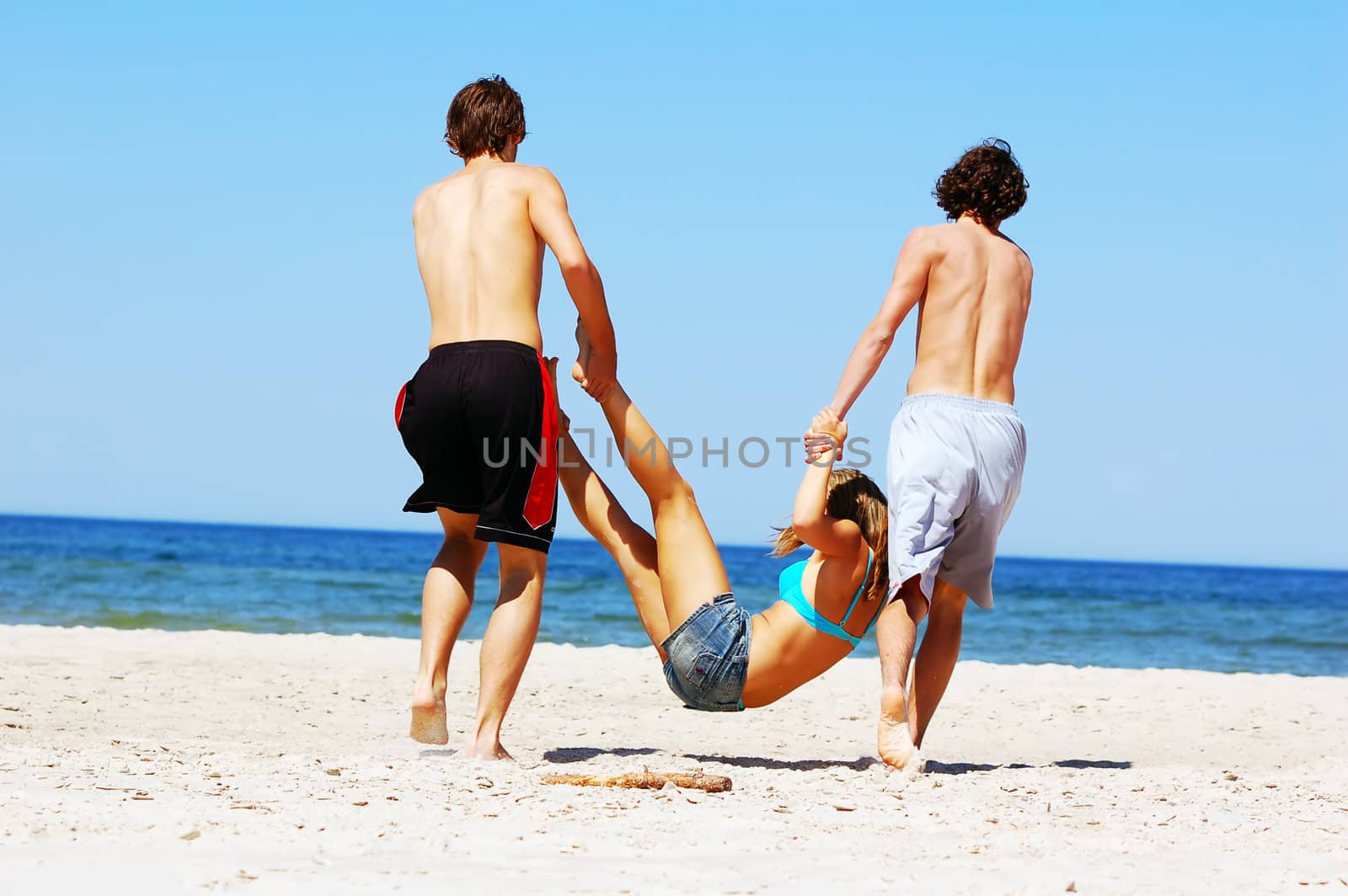 Young attractive friends having fun the summer beach