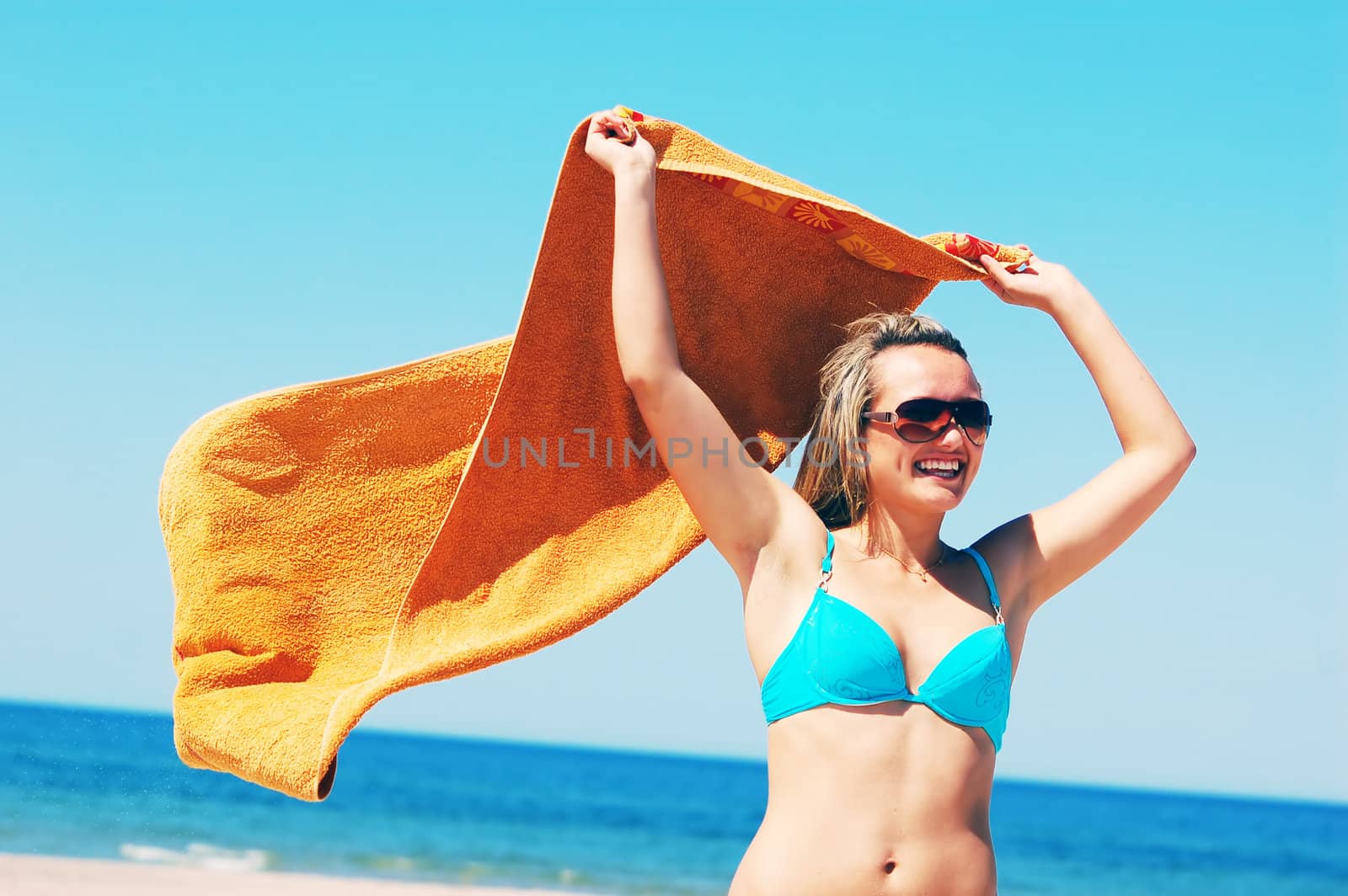 Young attractive woman enjoying summertime on the beach