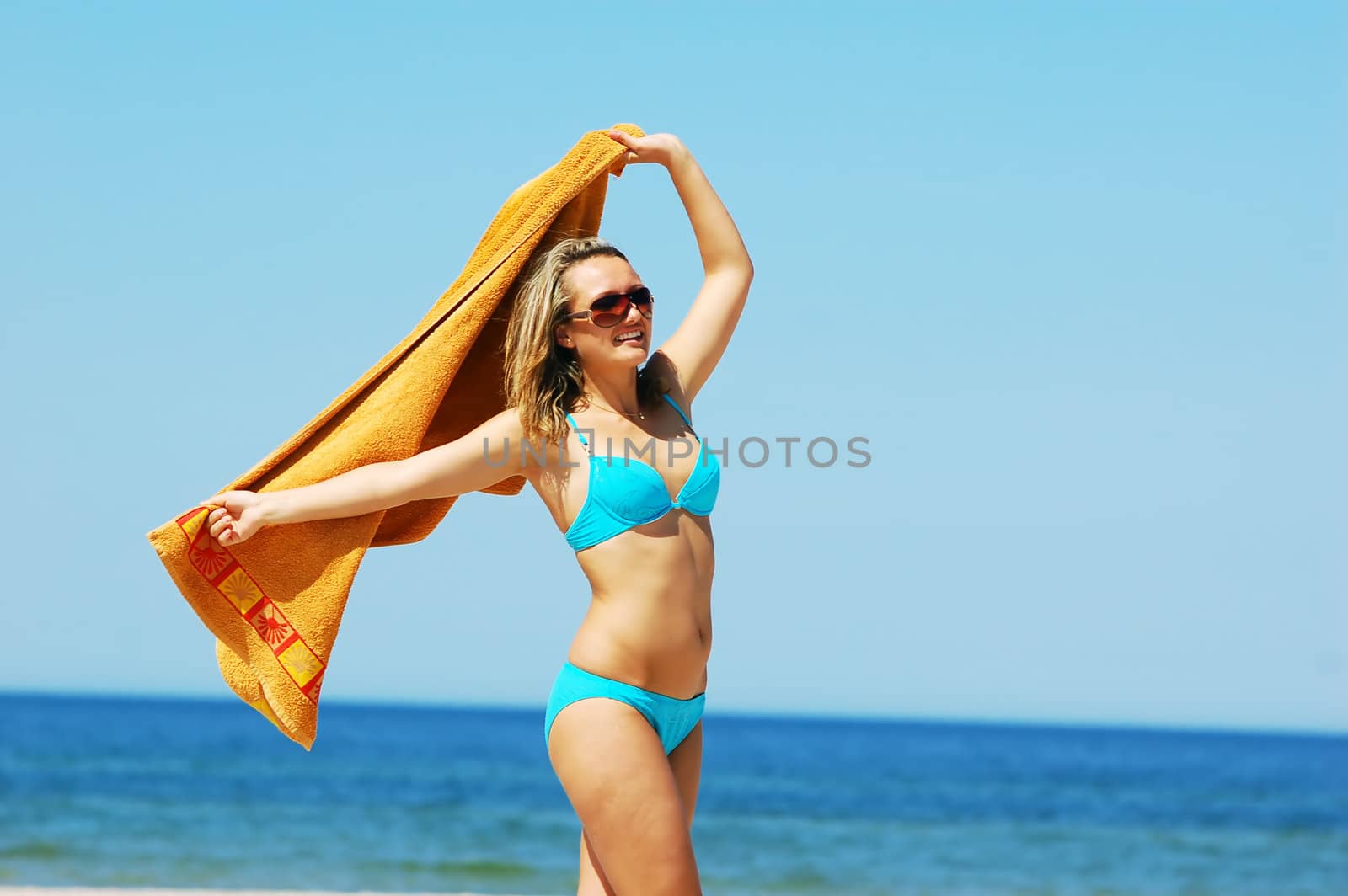 Young attractive woman enjoying summertime on the beach